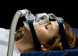 Female Demonstrating How a CPAP Face Mask is Installed and Used Female Demonstrating How a CPAP Face Mask is Installed and Used